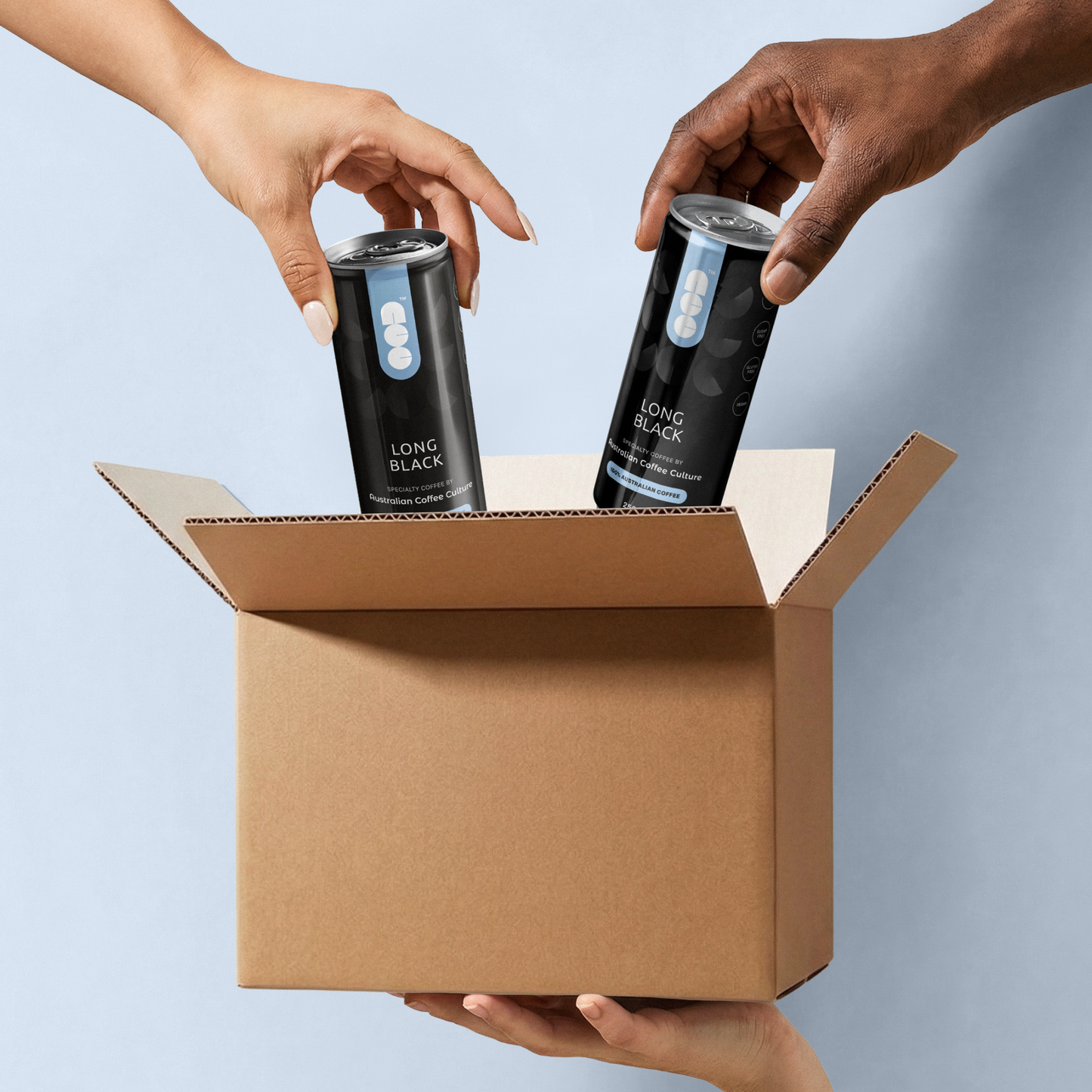 Hands placing Australian Coffee Culture Long Black cans into a cardboard box